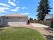Rear of house with side yard, gravel border, and parking area at 420 E 104Th Pl, Northglenn, CO 80233