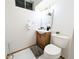 This bathroom features a white tiled floor, light wood vanity, and modern fixtures at 420 E 104Th Pl, Northglenn, CO 80233