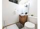 This bathroom features a white tiled floor, light wood vanity, and modern fixtures at 420 E 104Th Pl, Northglenn, CO 80233