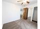 Carpeted bedroom features a ceiling fan, closet with mirror sliding doors, and white walls at 420 E 104Th Pl, Northglenn, CO 80233