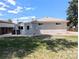 Back exterior of home with painted brick and access to backyard at 420 E 104Th Pl, Northglenn, CO 80233