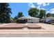 Inviting single-story home featuring brick accents and a spacious driveway on a sunny day at 420 E 104Th Pl, Northglenn, CO 80233