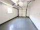 This garage features a white door, finished walls, and painted floors at 420 E 104Th Pl, Northglenn, CO 80233