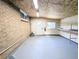 This garage features a rear exit door, brick exterior, and built-in shelves at 420 E 104Th Pl, Northglenn, CO 80233