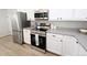 Well-equipped kitchen features stainless steel appliances, granite countertops, and white cabinetry at 420 E 104Th Pl, Northglenn, CO 80233