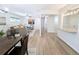 Spacious and modern living area with hardwood floors, leading to a well-lit hallway and kitchen at 420 E 104Th Pl, Northglenn, CO 80233