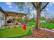 Backyard featuring a putting green, covered patio, and multiple spaces for relaxation and recreation at 3200 Ames St, Wheat Ridge, CO 80212