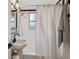 Bathroom featuring a pedestal sink, subway tile, and black trim at 3200 Ames St, Wheat Ridge, CO 80212