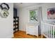 Bright bedroom featuring a white crib, changing table and hardwood floors at 3200 Ames St, Wheat Ridge, CO 80212