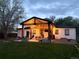 Backyard view featuring a covered patio illuminated by string lights creating a cozy ambiance at 3200 Ames St, Wheat Ridge, CO 80212
