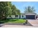 Charming single-story home with well-manicured lawn and a mature shade tree creating curb appeal at 3200 Ames St, Wheat Ridge, CO 80212