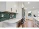 Bright, modern kitchen with white cabinets, stainless steel appliances, and hardwood floors at 3200 Ames St, Wheat Ridge, CO 80212