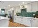 Bright modern kitchen with stainless steel appliances and stylish green backsplash at 3200 Ames St, Wheat Ridge, CO 80212