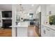 Bright kitchen with stainless appliances, breakfast bar, and open concept layout at 3200 Ames St, Wheat Ridge, CO 80212