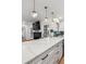 Open concept kitchen with breakfast bar, pendant lights, and stainless steel appliances at 3200 Ames St, Wheat Ridge, CO 80212
