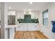 Modern kitchen with white cabinets, stainless steel appliances, and unique backsplash at 3200 Ames St, Wheat Ridge, CO 80212