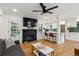 Bright living room with fireplace, hardwood floors, and an open layout connecting to the kitchen at 3200 Ames St, Wheat Ridge, CO 80212