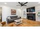 Cozy living room featuring hardwood floors, a modern fireplace, and a stylish gray sofa at 3200 Ames St, Wheat Ridge, CO 80212