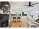 Open living space with fireplace and breakfast bar leading to a modern, well-equipped kitchen at 3200 Ames St, Wheat Ridge, CO 80212