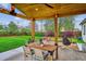 Covered patio with wooden ceiling, string lights, backyard access, and an outdoor dining area at 3200 Ames St, Wheat Ridge, CO 80212