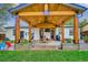 An outdoor covered patio space with a wooden ceiling, string lights, and a table at 3200 Ames St, Wheat Ridge, CO 80212