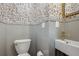 Stylish powder room features charming wallpaper, a modern vanity, and elegant fixtures at 3200 Ames St, Wheat Ridge, CO 80212