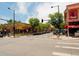 Street view showcasing a charming neighborhood with cafes, shops, and tree-lined streets at 3200 Ames St, Wheat Ridge, CO 80212