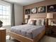 Cozy bedroom featuring sports-themed decor, a comfortable bed, and a view from the window at 24005 E Utah Pl, Aurora, CO 80018
