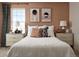 Comfortable bedroom featuring neutral tones, two bedside tables, and a large window at 24005 E Utah Pl, Aurora, CO 80018