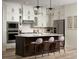 Stylish kitchen with white cabinets, stainless steel appliances, and an island with barstool seating at 24005 E Utah Pl, Aurora, CO 80018