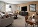 Cozy living room featuring a comfortable sofa, stylish decor, and a large window for natural light at 24005 E Utah Pl, Aurora, CO 80018