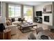 Bright and open living room featuring a fireplace, comfortable seating, and large windows at 24005 E Utah Pl, Aurora, CO 80018