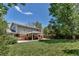 Spacious backyard with a covered patio, lush lawn, and mature trees at 8696 E Easter Ave, Centennial, CO 80112
