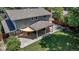An outdoor patio area covered with a shade with a green lawn in the backyard of a beautiful home at 8696 E Easter Ave, Centennial, CO 80112