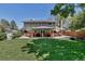 Expansive backyard with patio, lush lawn, and mature trees perfect for outdoor enjoyment at 8696 E Easter Ave, Centennial, CO 80112