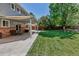 Large patio space for outdoor entertaining overlooks the well-manicured lawn at 8696 E Easter Ave, Centennial, CO 80112