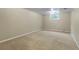 Finished basement space with neutral carpet and natural light from window at 8696 E Easter Ave, Centennial, CO 80112