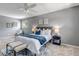 Comfortable bedroom with a plush bed, ceiling fan, a cozy rug, and two windows with backyard views at 8696 E Easter Ave, Centennial, CO 80112