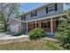 Inviting two-story home with brick accents, a cozy porch, and well-kept landscaping at 8696 E Easter Ave, Centennial, CO 80112