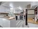 Functional kitchen with white cabinets, stainless steel appliances, and a breakfast bar at 8696 E Easter Ave, Centennial, CO 80112