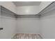 Empty walk-in closet with neutral carpet, shelving, and overhead bars at 8696 E Easter Ave, Centennial, CO 80112