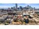 Aerial view of neighborhood homes with downtown skyline in the background at 1741 N Emerson St, Denver, CO 80218