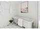 Bright bathroom featuring a standalone tub, white tile, and simple decor at 1741 N Emerson St, Denver, CO 80218