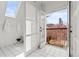 Bright bathroom features a door leading to a balcony with city views at 1741 N Emerson St, Denver, CO 80218