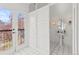 Stylish bathroom with a pedestal sink, grid tiled floors, and a door to an outdoor balcony at 1741 N Emerson St, Denver, CO 80218