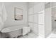 Modern bathroom featuring a standalone tub and a door leading to a balcony with city views at 1741 N Emerson St, Denver, CO 80218