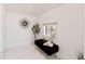 Cozy bedroom nook featuring a black velvet bench, decorative tree, and a sunburst mirror at 1741 N Emerson St, Denver, CO 80218