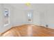 Sunlit bedroom with hardwood floors and two windows, offering ample natural light at 1741 N Emerson St, Denver, CO 80218