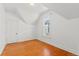 Bright bedroom with hardwood floors and a charming window view at 1741 N Emerson St, Denver, CO 80218