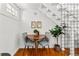 Charming dining area featuring hardwood floors, modern light fixture, and adjacent staircase at 1741 N Emerson St, Denver, CO 80218